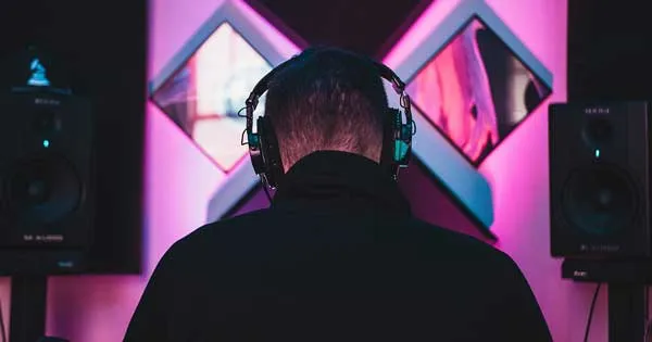 A producer making music, facing away from the camera.