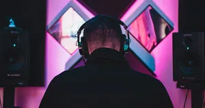 A producer making music, facing away from the camera.