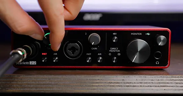 An image of an electric guitar cable plugged into the Hi-Z input of a Scarlett 2i2 audio interface.