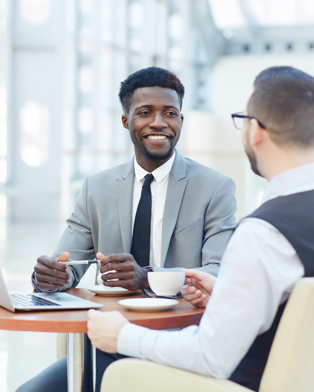 Two business men at a cafe with a laptop