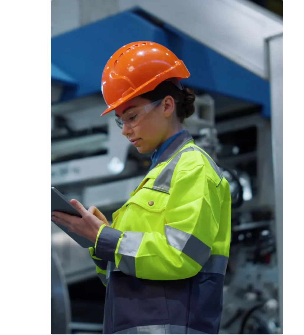 Image of maintenance worker looking at MaintainX application on tablet device
