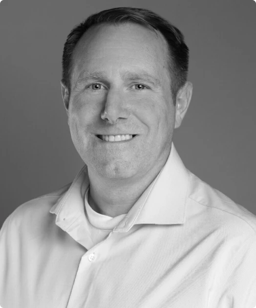 A black and white photo of Aron England, the CPO of Rev.