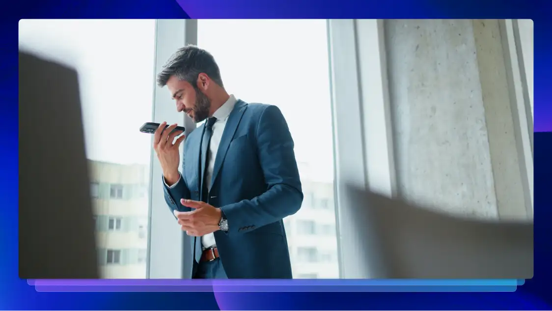 A man dressed in a suit speaks on his cell phone, appearing focused and engaged in a conversation